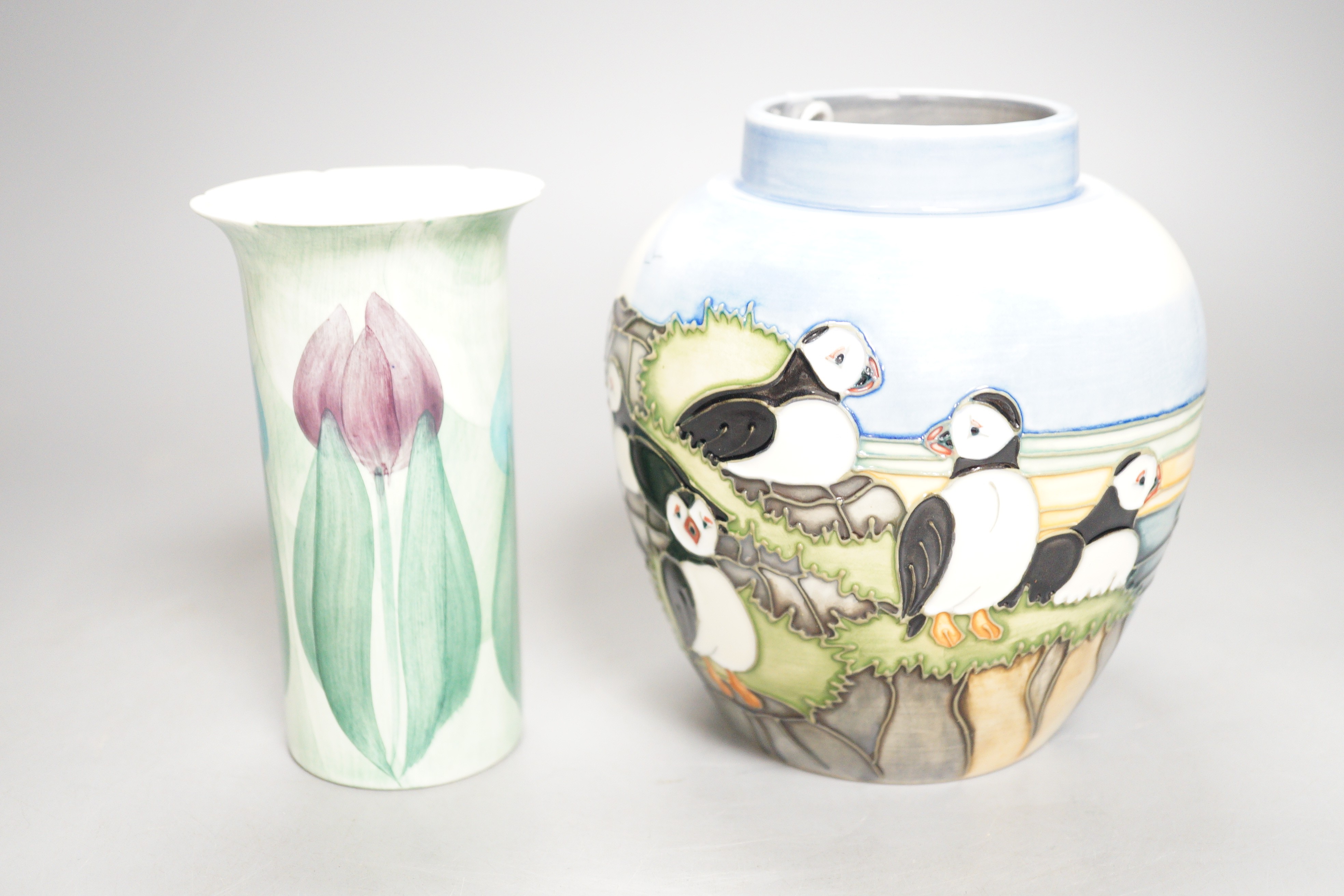 A Moorcroft pottery jar, decorated with puffins and a Jersey pottery 